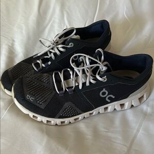 On Running White and Blue Athletic Shoes with Cloud-Like Sole